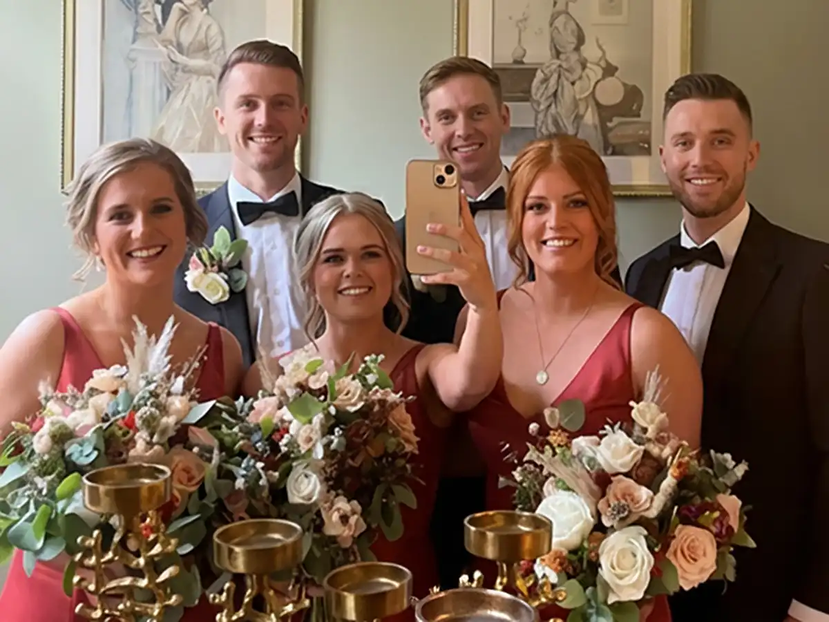 Wedding party taking a selfie with QR Code